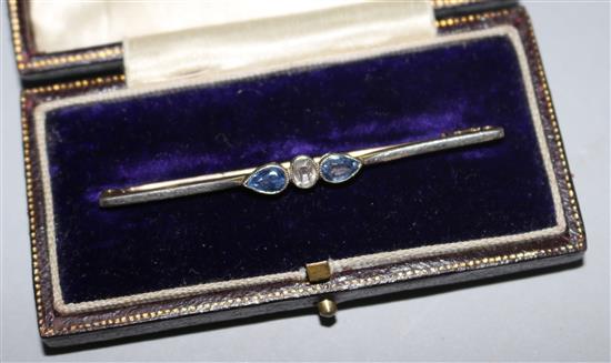 An early 20th century 15ct gold, sapphire and diamond three stone bar brooch, 60mm.